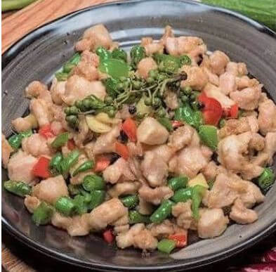 Tender, bone-in chicken pieces tossed with fresh green peppercorns and sliced chili peppers.