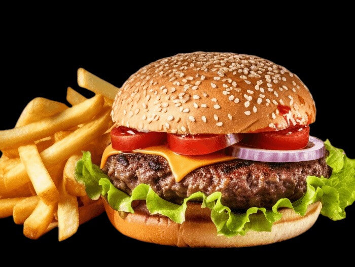 Thick beef patty with melted cheese, lettuce, tomatoes, onions, pickles, mustard, all stacked in a glossy artisan bun.