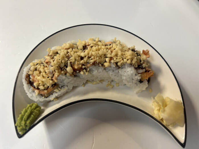Shrimp Tempura Roll with crispy double shrimp tempura, avocado, crab, cream cheese, and crunchy topping.