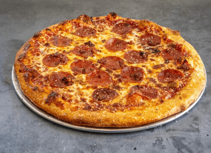 Meat lovers pizza with pepperoni, sausage, bacon, pizza sauce, and melted mozzarella cheese