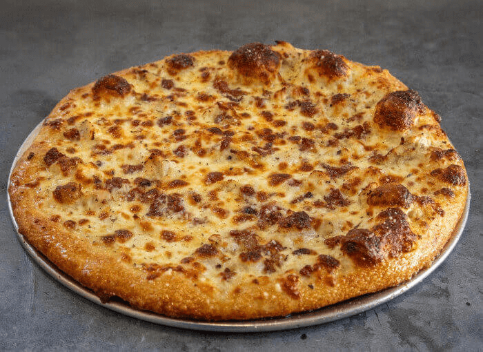 Chicken bacon ranch pizza with creamy ranch sauce, chicken, bacon, and cheese