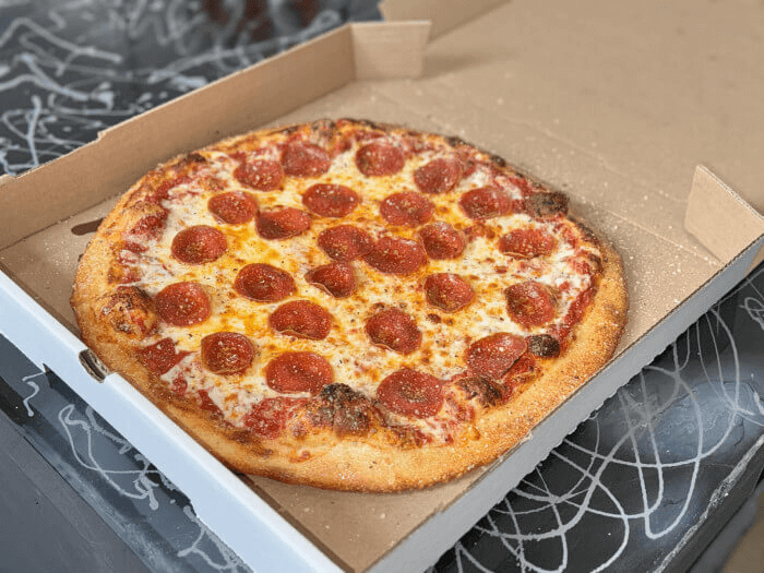 Classic pepperoni and cheese pizza with rich tomato sauce and melted mozzarella
