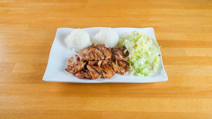 Teriyaki chicken plated with sesame seeds