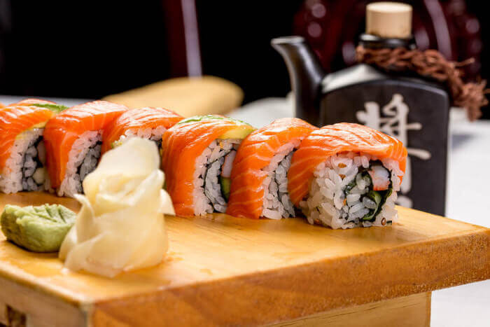 Gold Dragon sushi roll topped with salmon slices in Downtown Indianapolis