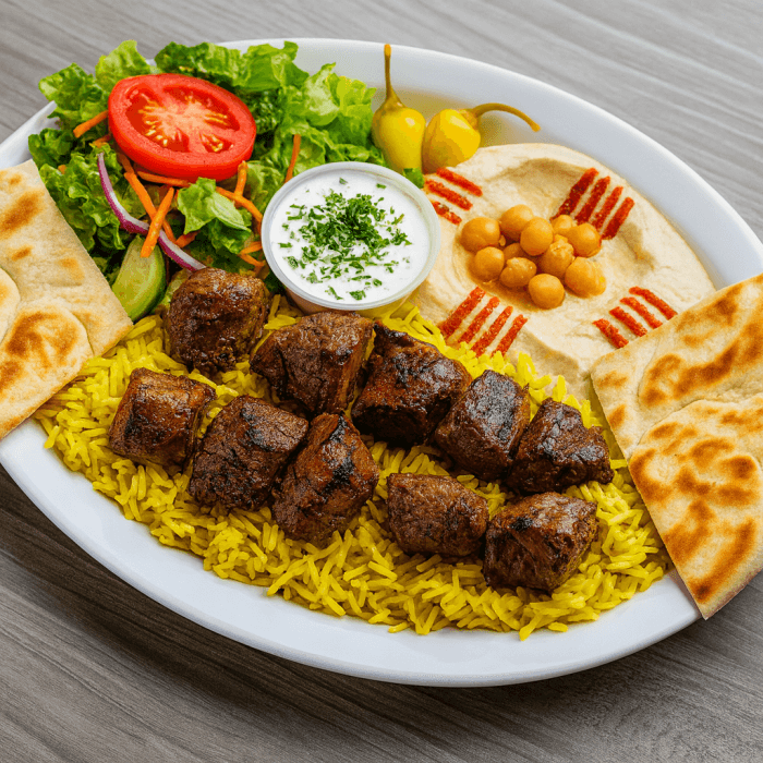 One skewer of Chicken & Beef kabob. Seasoned Basmati rice. Side of hummus or baba ghanoush or Tzatziki, side salad and grilled pita bread.
