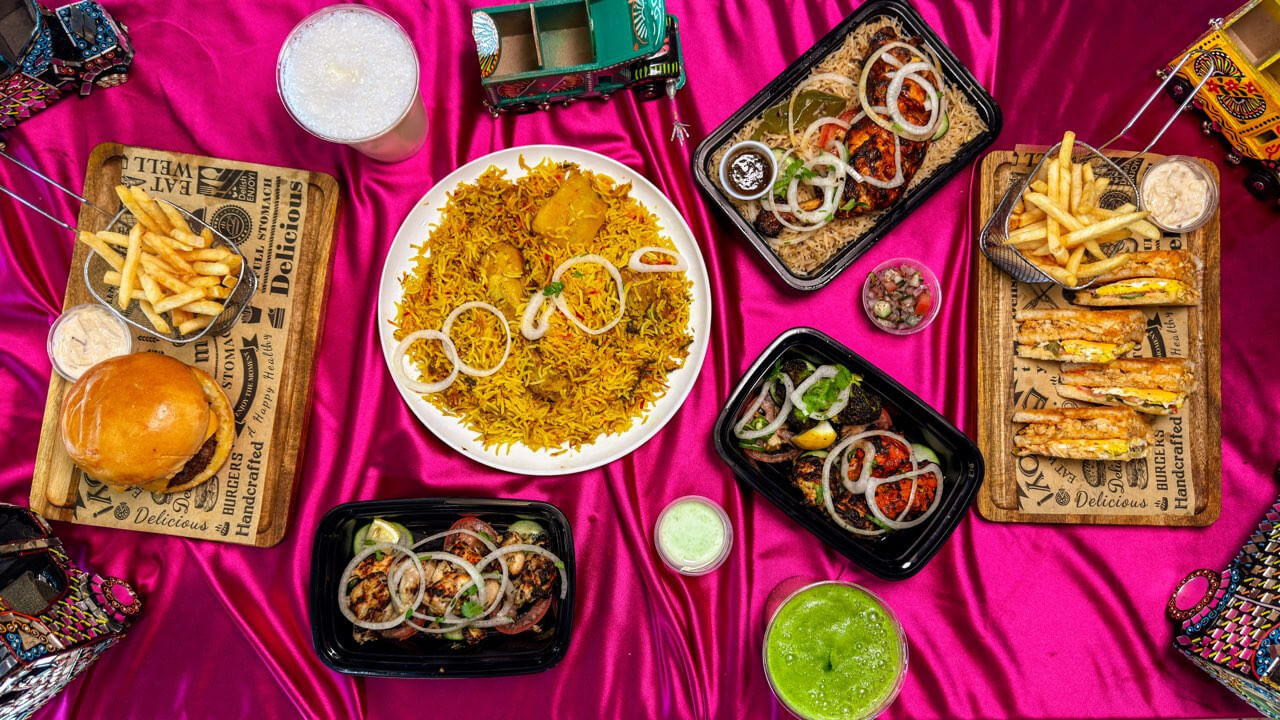 Overhead spread of Pakistani street food and Biryani at Burns Road Kitchen, West Powelton PA.