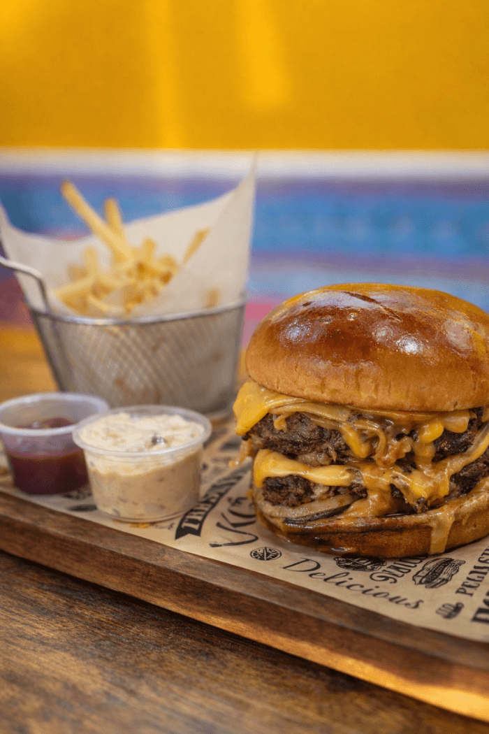 Hand-pressed Chapli Burger with crispy fries and coleslaw in West Powelton, Philadelphia.
