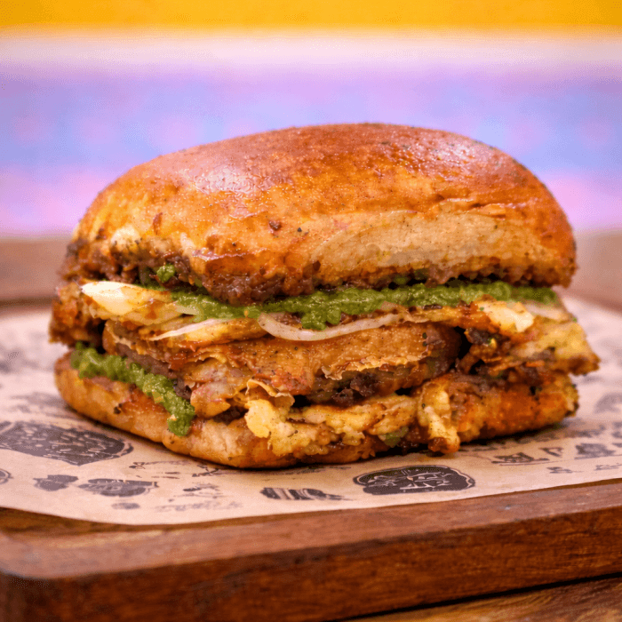 Karachi-style street food Bun Kabab with green chutney and onions in Mill Creek.