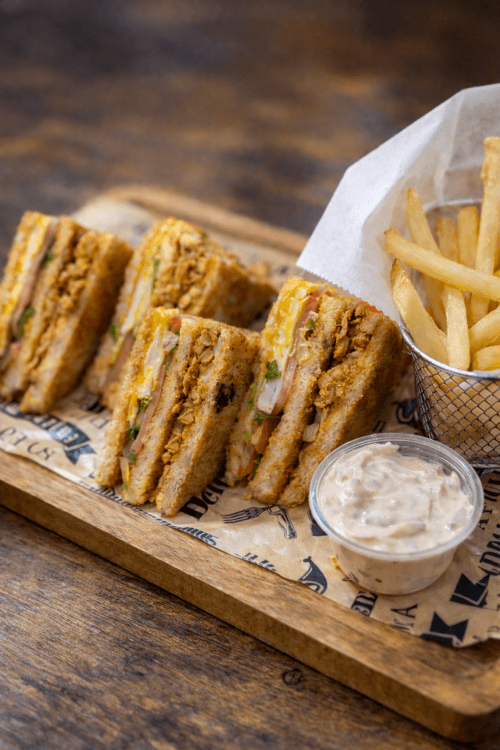 Triple-layer Karachi Club Sandwich with chicken steak and fries for delivery in West Powelton.