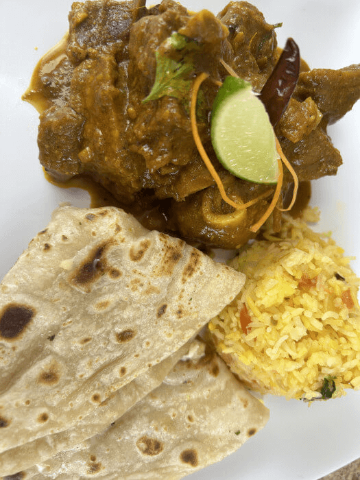 Rich goat curry with bone-in pieces