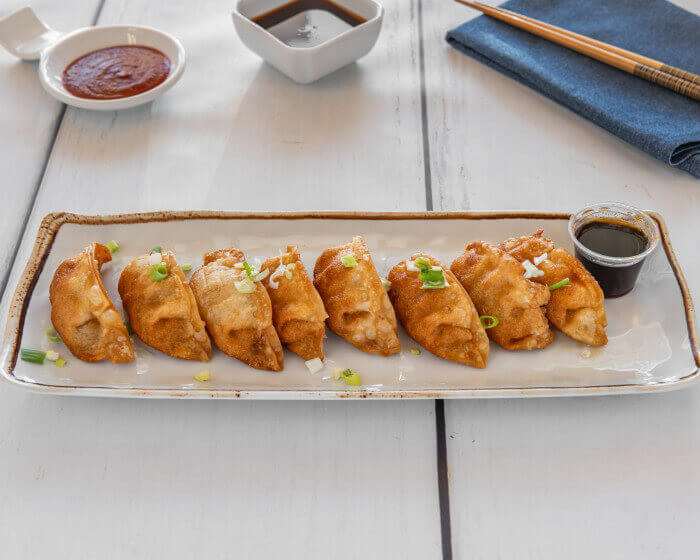 Crispy deep-fried porGyoza dumplings with dipping sauce at Manna Teriyaki Pinehurst