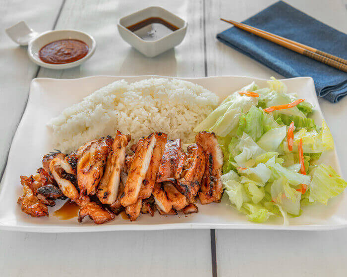 Tender charbroiled chicken on white rice with salad and house dressing