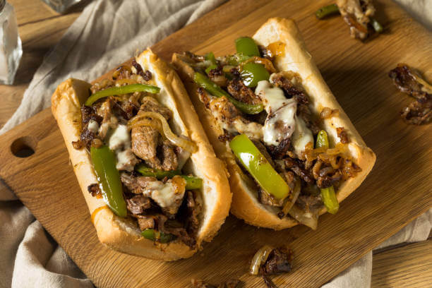 Philly steak sub with fries and salad